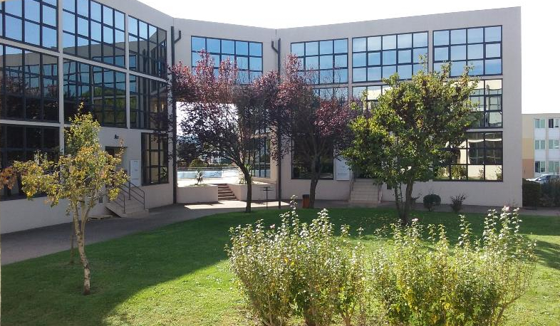 Siège du groupe NORMAXIS — Espace Wagner Bâtiment A2, 10 rue du Lieutenant Parayre, Aix-en-Provence. Façade vitrée avec jardin et végétation méditerranéenne.